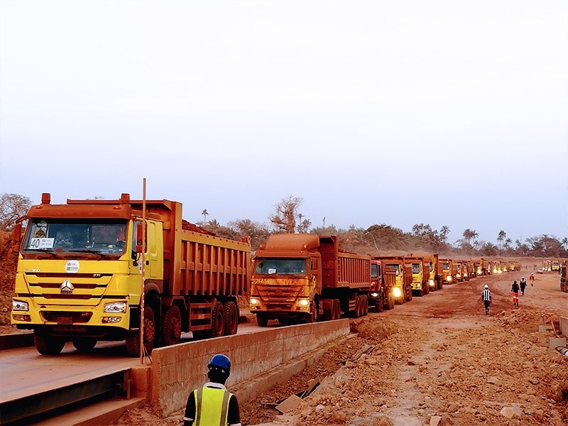 Fleet of HOWO tipper trucks hauling on a site in West Africa